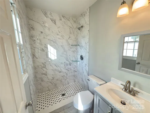 a bathroom with a sink toilet and shower