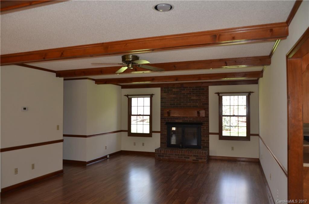 245 Gregory Road Salisbury, NC 28147 - Photo 5 of 16 a view of an empty room with wooden floor and a window