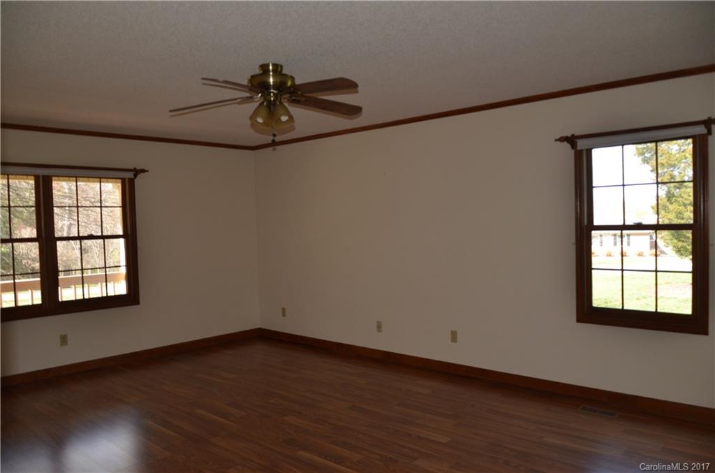 245 Gregory Road Salisbury, NC 28147 - Photo 9 of 16 a view of empty room with wooden floor and fan