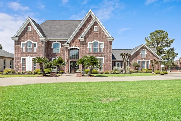 a front view of a house with a yard and potted plants