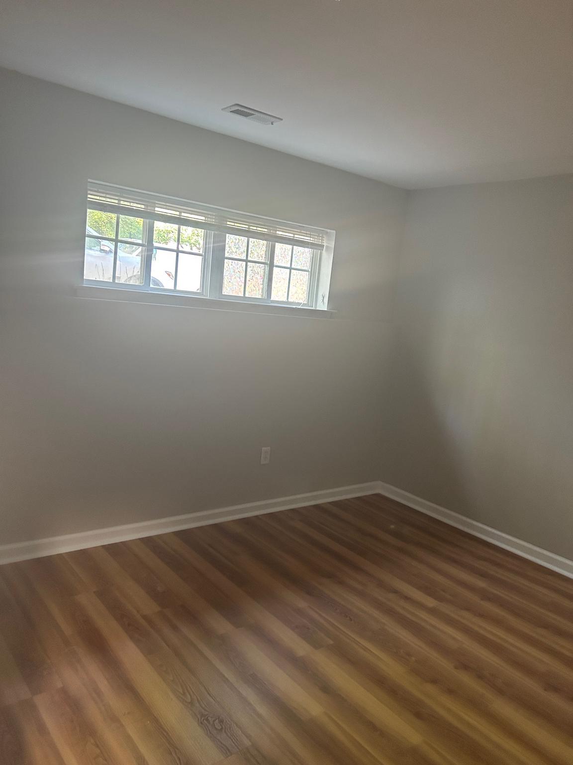 10109 Tulip Tree Drive Bowie, MD 20721 - Photo 2 of 8 a view of an empty room with wooden floor and a window