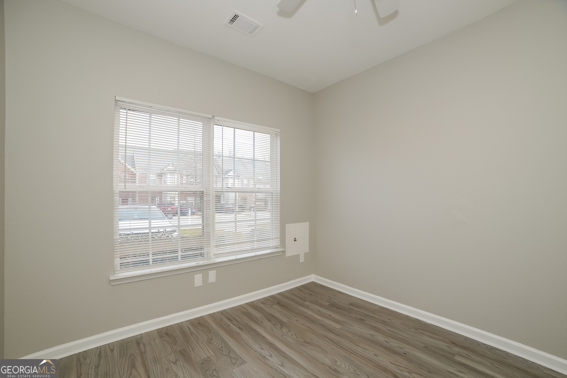 7111 Brookview Way Riverdale, GA 30274 - Photo 12 of 17 a view of an empty room with wooden floor and a window