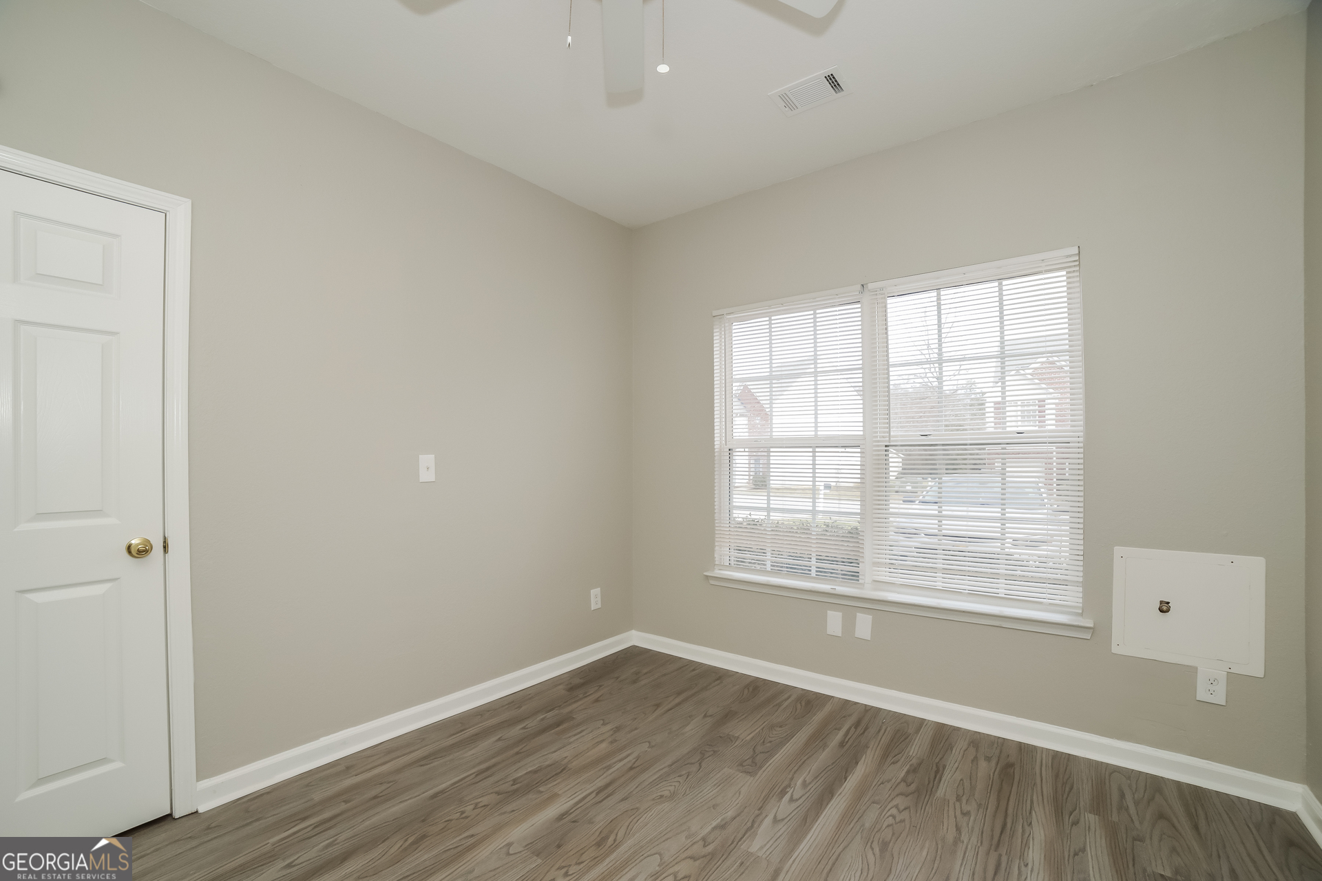 7111 Brookview Way Riverdale, GA 30274 - Photo 13 of 17 an empty room with wooden floor and windows
