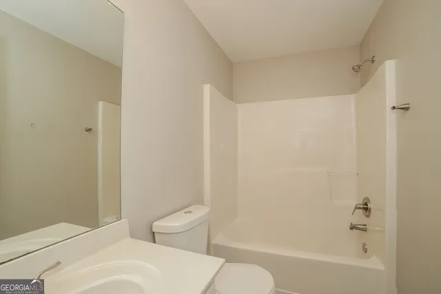 a bathroom with a toilet and a bathtub