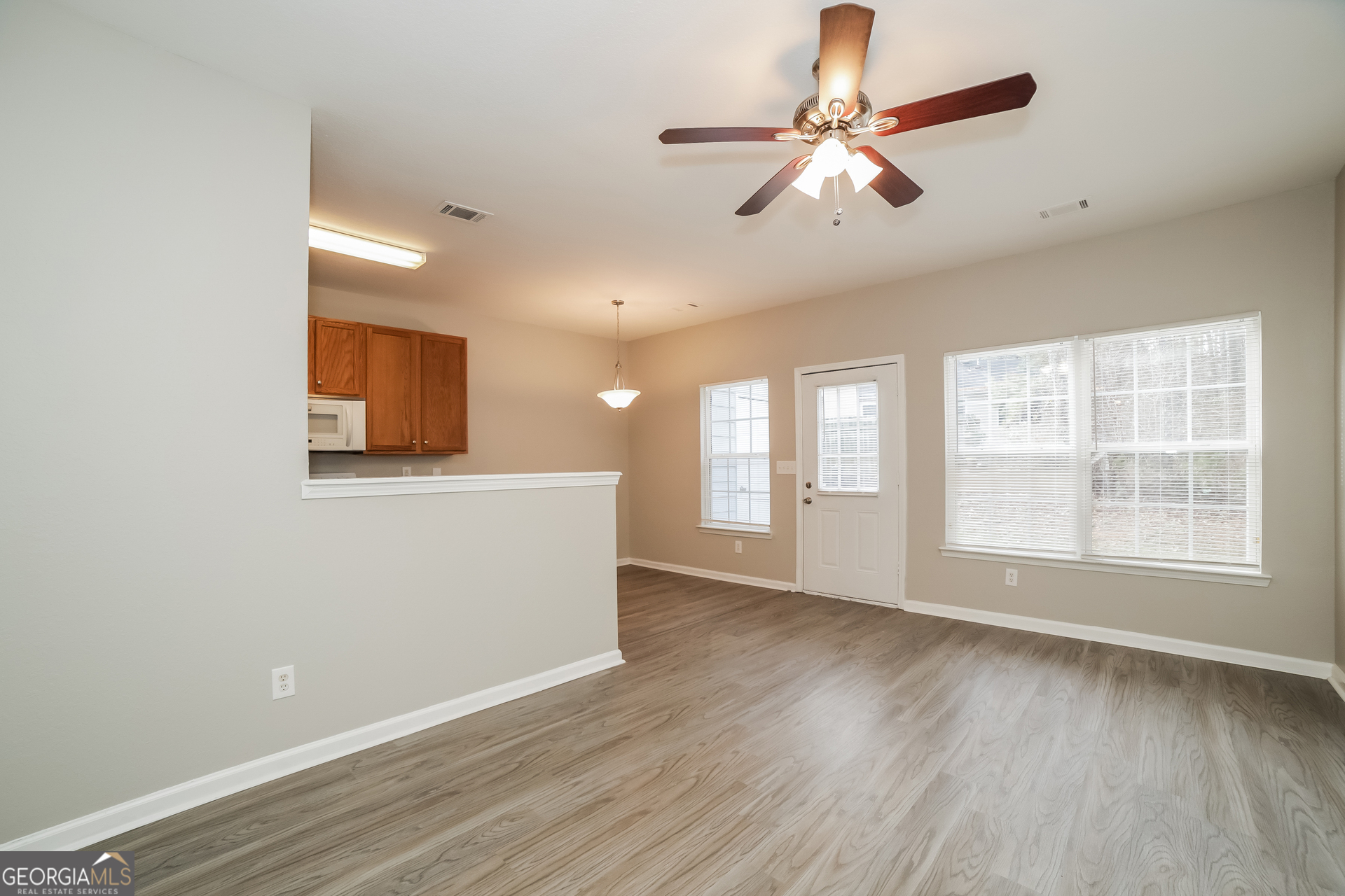 7111 Brookview Way Riverdale, GA 30274 - Photo 5 of 17 a view of an empty room with window and wooden floor