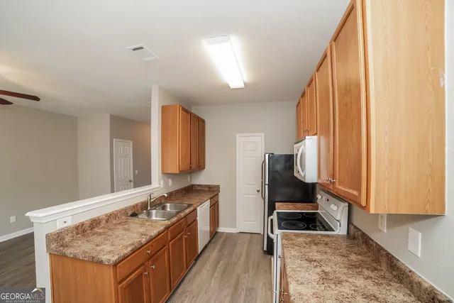 a kitchen with a stove and a sink