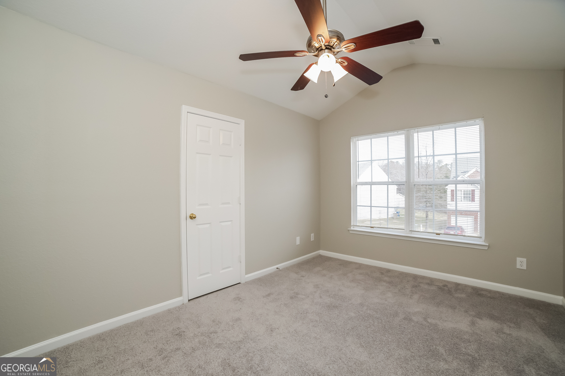 7111 Brookview Way Riverdale, GA 30274 - Photo 8 of 17 an empty room with a window and a fan
