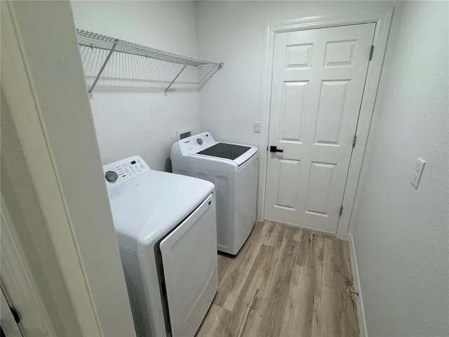 a view of a storage and utility room with washer and dryer