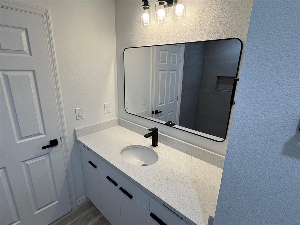 3244 East Deal Street Inverness, FL 34453 - Photo 10 of 17 a bathroom with a sink and mirror