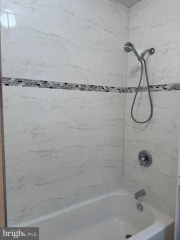 a bathroom with a shower and a bathtub