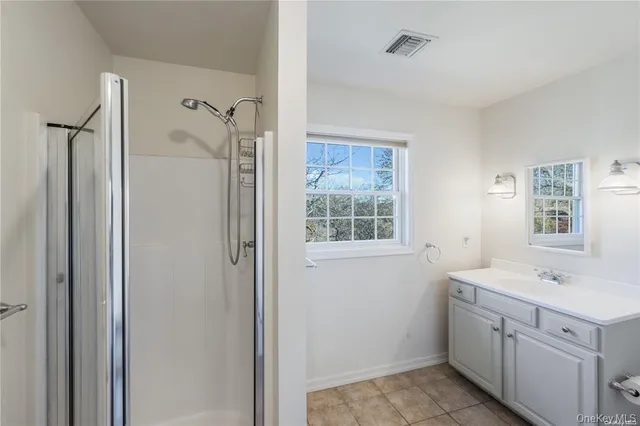 a large white kitchen with stainless steel appliances