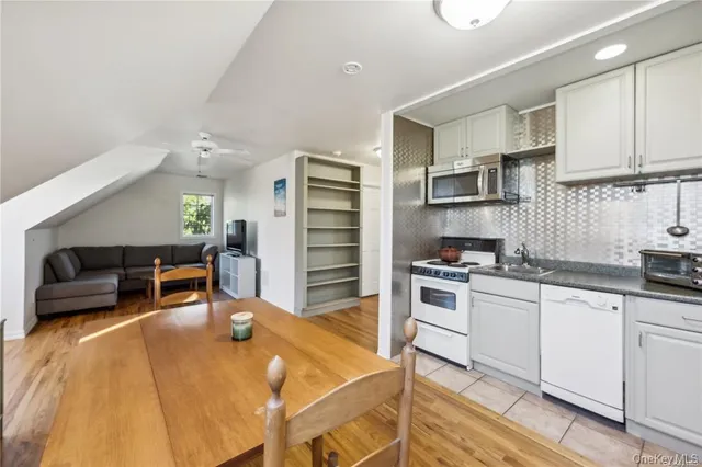 a kitchen with stainless steel appliances kitchen island granite countertop a sink and cabinets