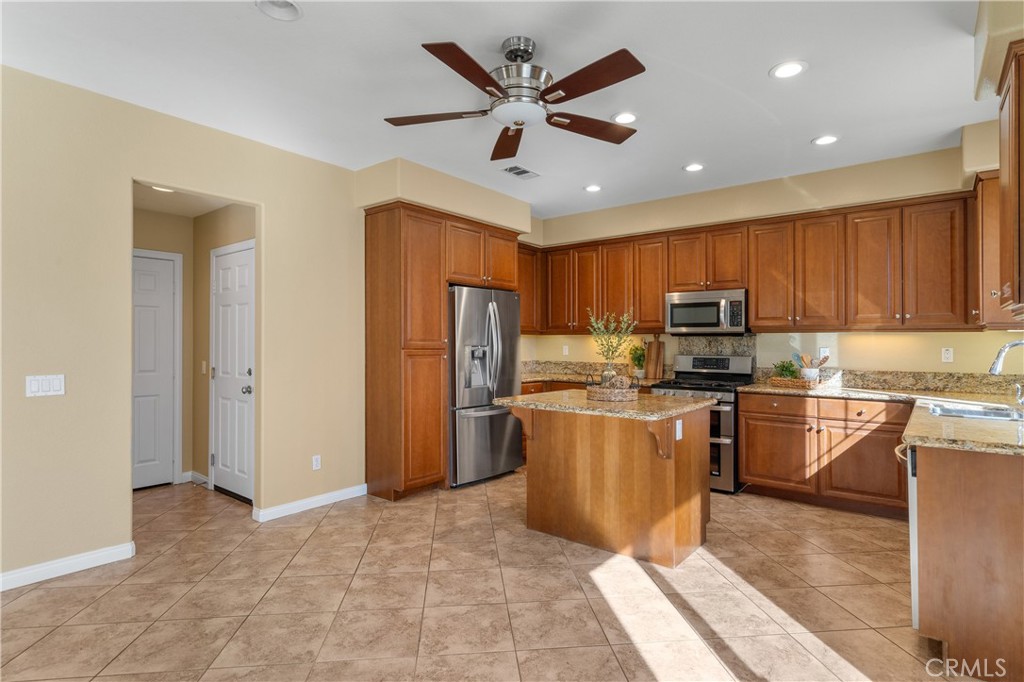 28817 Edenton Way Temecula, CA 92591 - Photo 21 of 56 a kitchen with stainless steel appliances granite countertop a refrigerator a stove top oven a sink dishwasher and a refrigerator