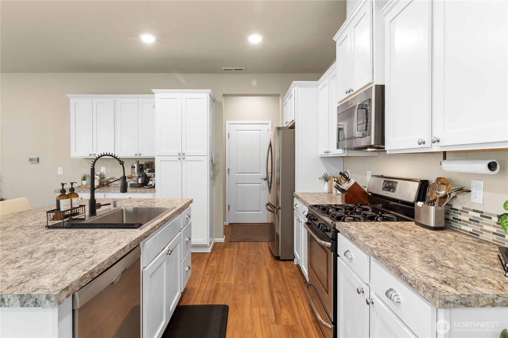 3923 Jett Lane Lacey, WA 98516 - Photo 11 of 40 a kitchen with sink a refrigerator and cabinets