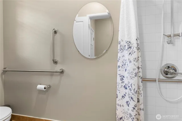 a bathroom with a toilet and a shower
