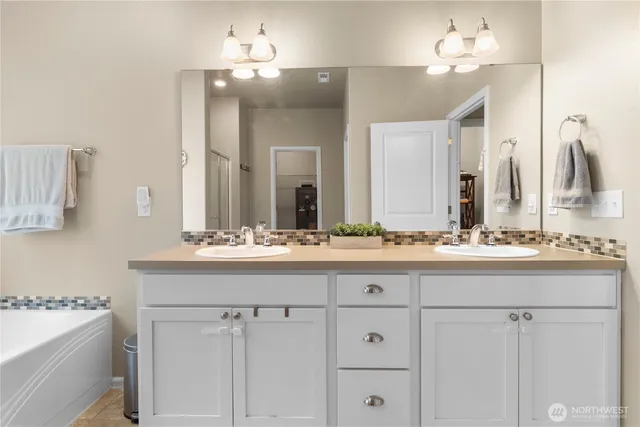 a bathroom with a sink vanity and mirror