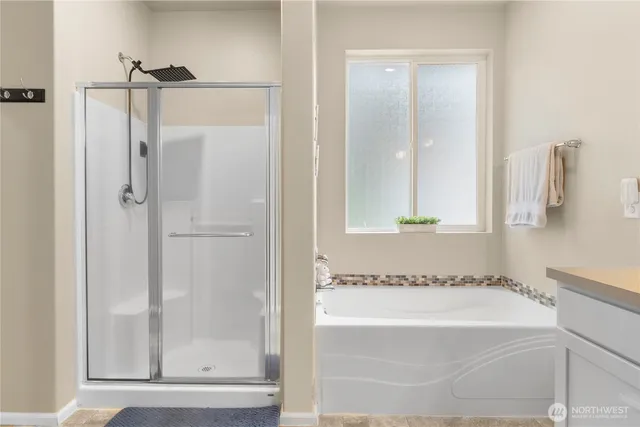 a bathroom with a tub and a shower
