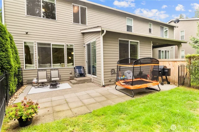 a view of a house with backyard sitting area and garden