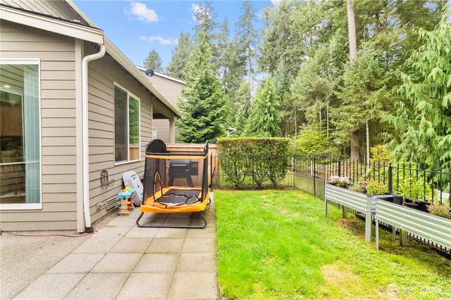 a view of backyard with swimming pool and sitting area