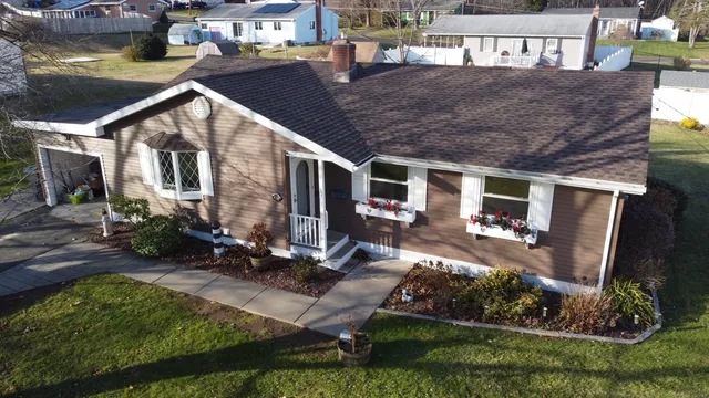 a view of house with yard