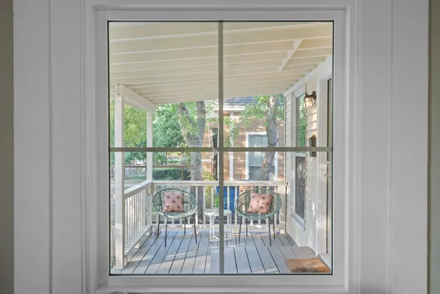 a view of a room with wooden floor and windows