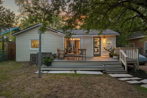 a view of house and wooden deck