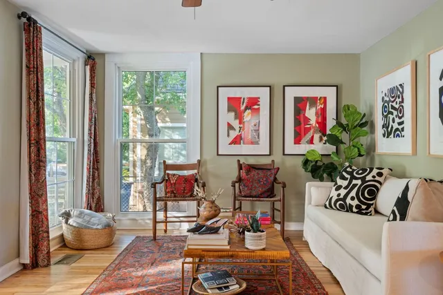 a living room with furniture and next to a window
