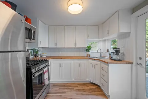 a kitchen with a sink appliances and cabinets