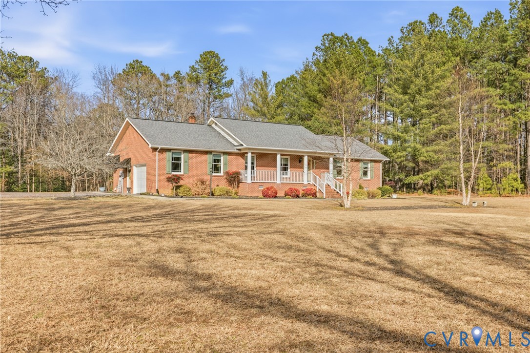 6606 West Quaker Road Disputanta, VA 23842 - Photo 4 of 32 Ranch-style home with a porch, a garage, a front y