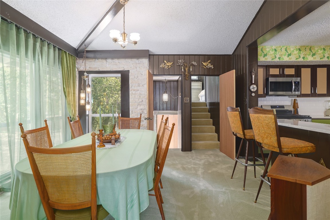 1818 Vance Circle Austin, TX 78701 - Photo 15 of 40 a dining room with furniture a chandelier and wooden floor