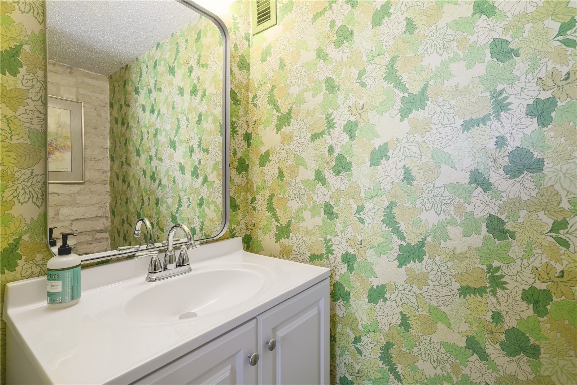 1818 Vance Circle Austin, TX 78701 - Photo 19 of 40 a bathroom with a sink and a mirror