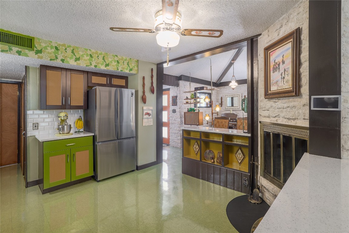 1818 Vance Circle Austin, TX 78701 - Photo 20 of 40 a kitchen with stainless steel appliances granite countertop a refrigerator a stove and a sink with wooden floor