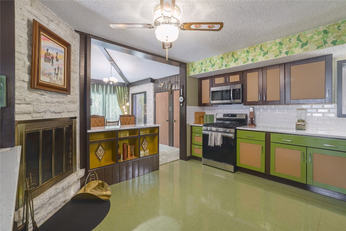 1818 Vance Circle Austin, TX 78701 - Photo 21 of 40 a kitchen with stainless steel appliances granite countertop a stove top oven a sink dishwasher a dining table and chairs with wooden floor