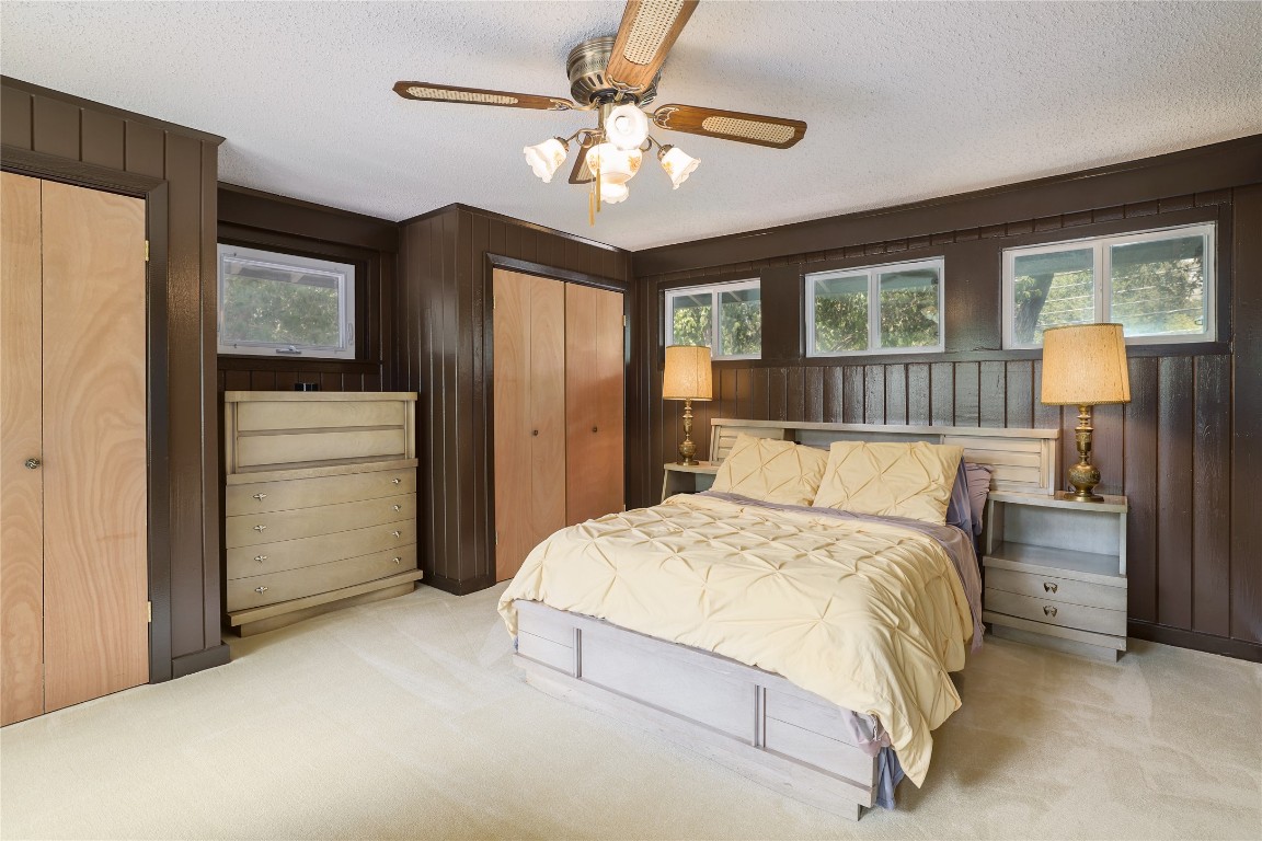 1818 Vance Circle Austin, TX 78701 - Photo 24 of 40 a bedroom with a large bed and a chandelier