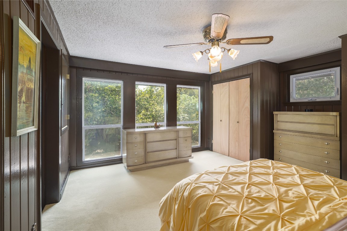 1818 Vance Circle Austin, TX 78701 - Photo 25 of 40 a bedroom with a large bed and a chandelier