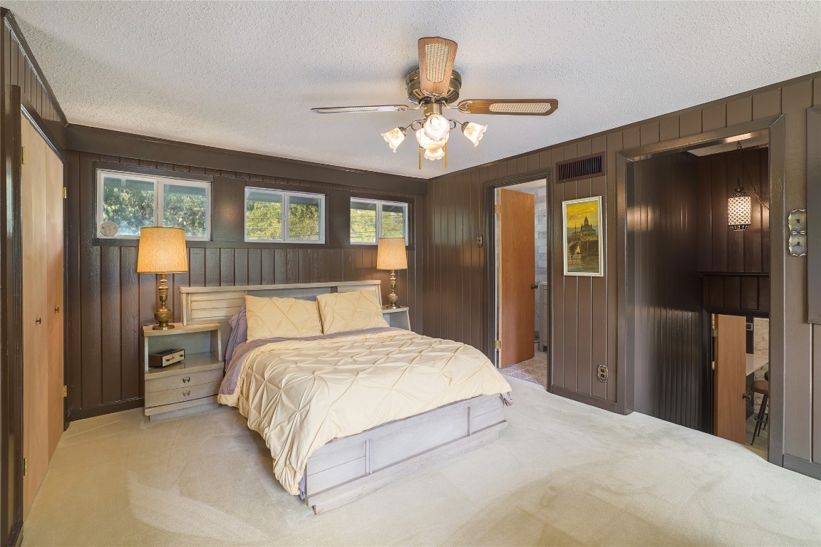 1818 Vance Circle Austin, TX 78701 - Photo 26 of 40 a bedroom with a large bed and a chandelier