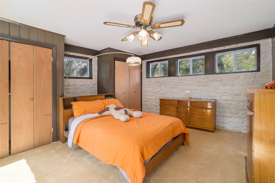 1818 Vance Circle Austin, TX 78701 - Photo 28 of 40 a bedroom with a bed and a chandelier