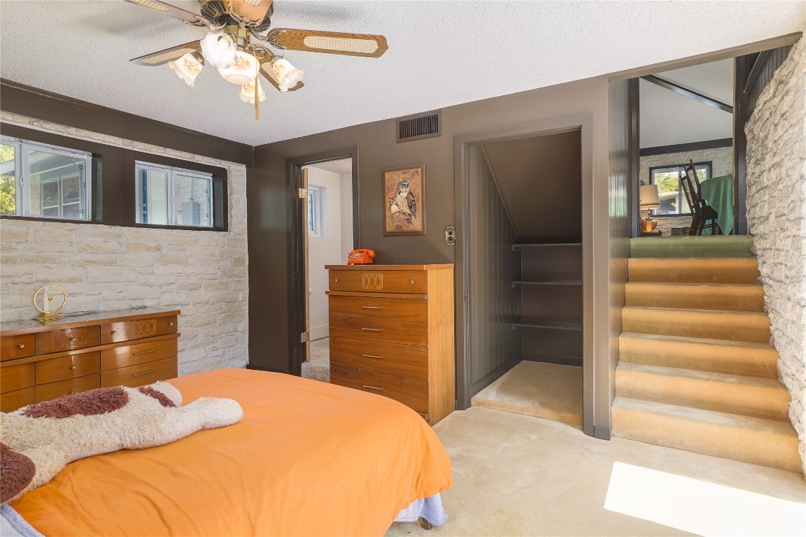 1818 Vance Circle Austin, TX 78701 - Photo 29 of 40 a bedroom with a bed and ceiling fan