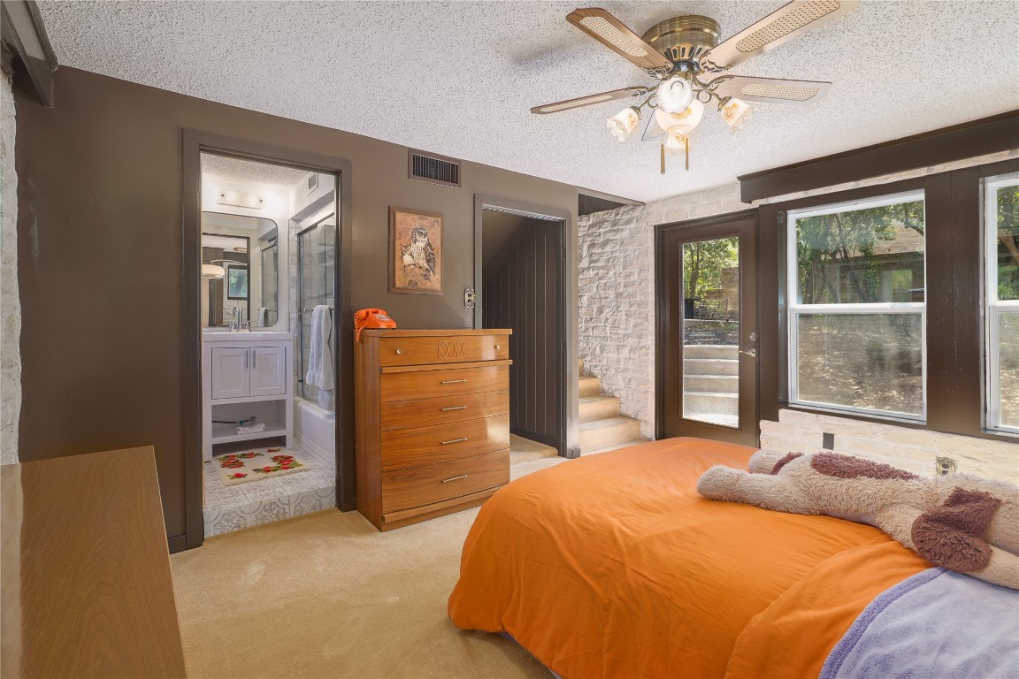 1818 Vance Circle Austin, TX 78701 - Photo 30 of 40 a bedroom with a large bed and a chandelier