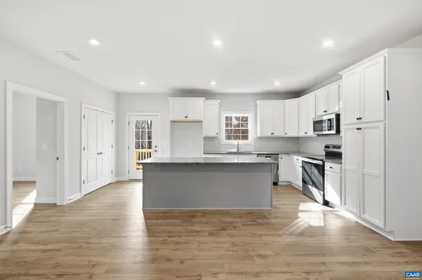 a kitchen with stainless steel appliances refrigerator sink and microwave