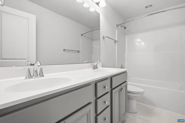 a bathroom with a sink a toilet a shower and a mirror