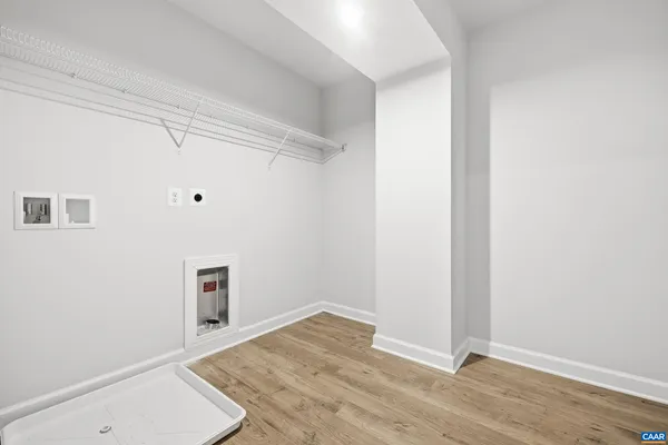 a view of a room with wooden floor