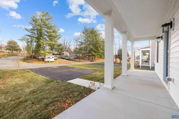 a view of a porch with yard and road
