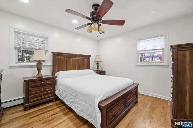 a bed room with a bed and a ceiling fan