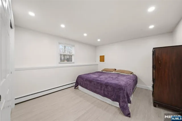 a spacious bedroom with a bed and a window