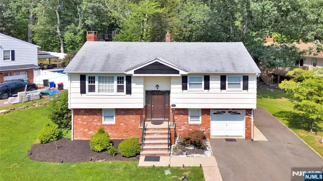 a front view of a house with a garden and plants