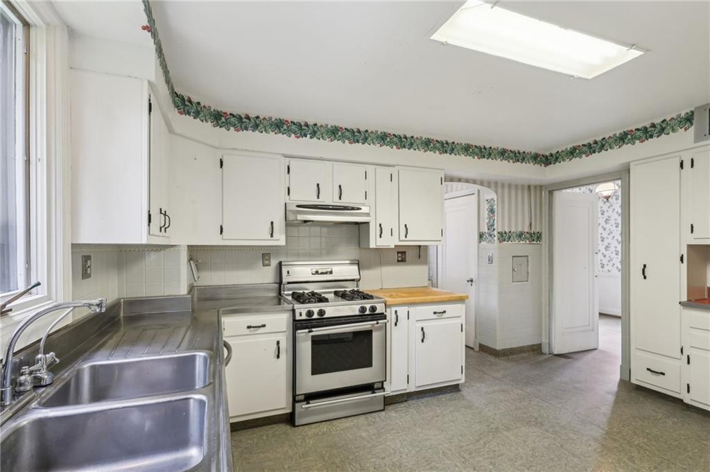 634 West Waldheim Road Pittsburgh, PA 15215 - Photo 18 of 50 a kitchen with stainless steel appliances a stove sink and refrigerator