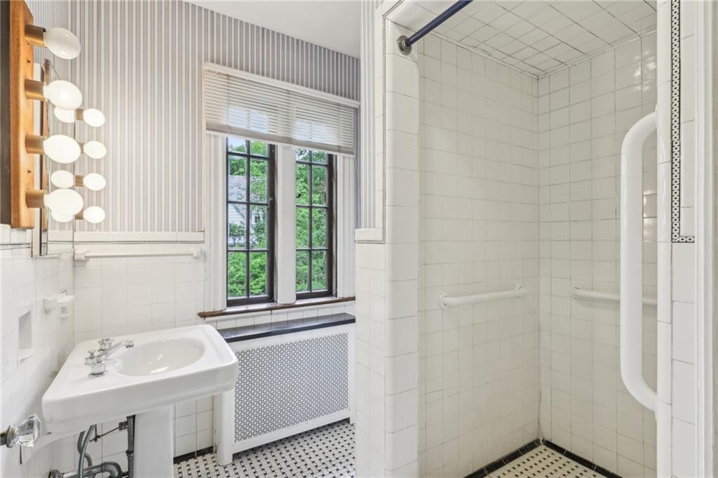 634 West Waldheim Road Pittsburgh, PA 15215 - Photo 32 of 50 a bathroom with a sink a window and a shower