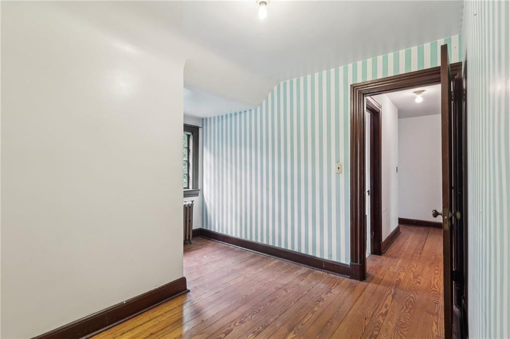 634 West Waldheim Road Pittsburgh, PA 15215 - Photo 39 of 50 an empty room with wooden floor and a bathroom