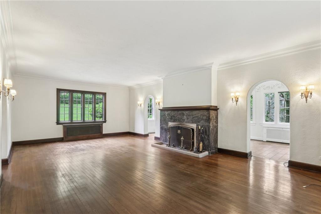 634 West Waldheim Road Pittsburgh, PA 15215 - Photo 6 of 50 an empty room with fireplace wooden floor and windows